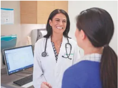 Female doctor chatting with female patient