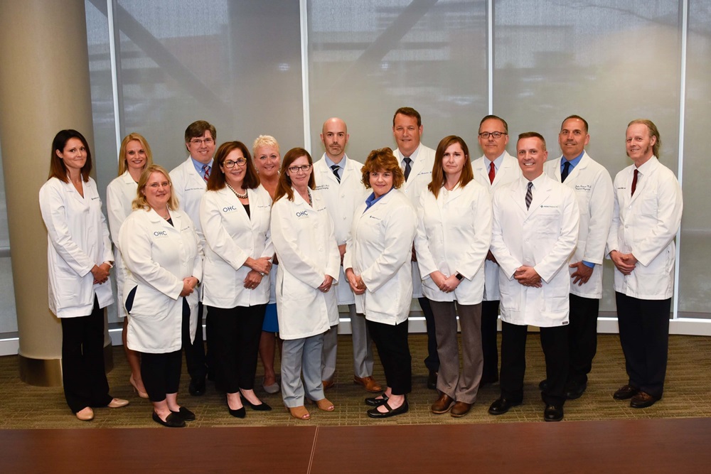 The Jewish Hospital Mercy Health Brain Tumor Center - Tumor Board Group photo of the staff , all wearing white lab coats.
